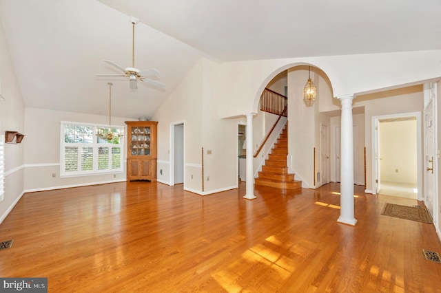 interior space with ceiling fan, high vaulted ceiling, decorative columns, and light hardwood / wood-style flooring