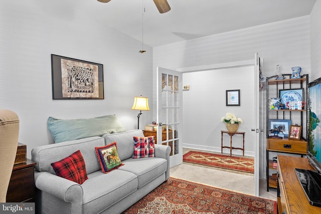 carpeted living room with ceiling fan