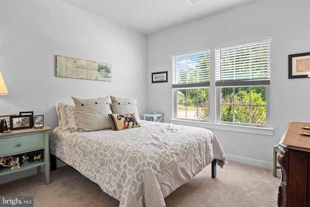 carpeted bedroom featuring multiple windows