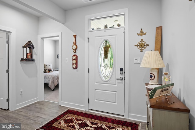 entryway with hardwood / wood-style flooring