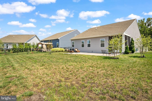 back of house featuring a patio area and a yard