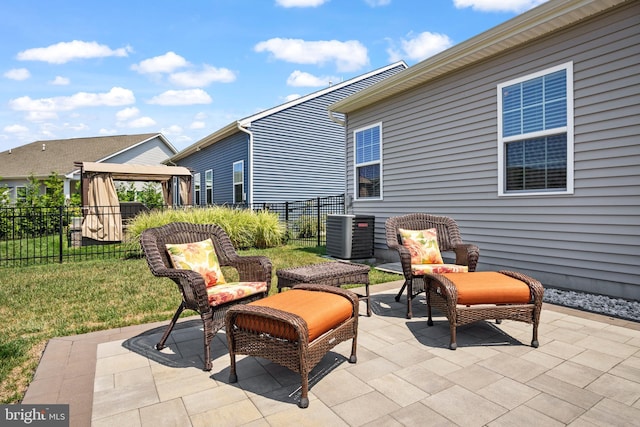 view of patio with central air condition unit and a gazebo