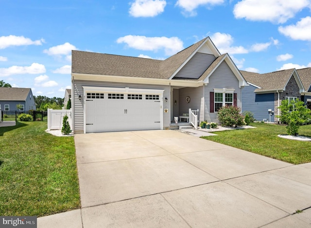 view of front facade with a front yard and a garage