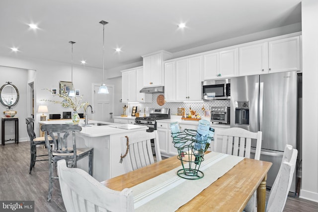 dining space with hardwood / wood-style flooring and sink