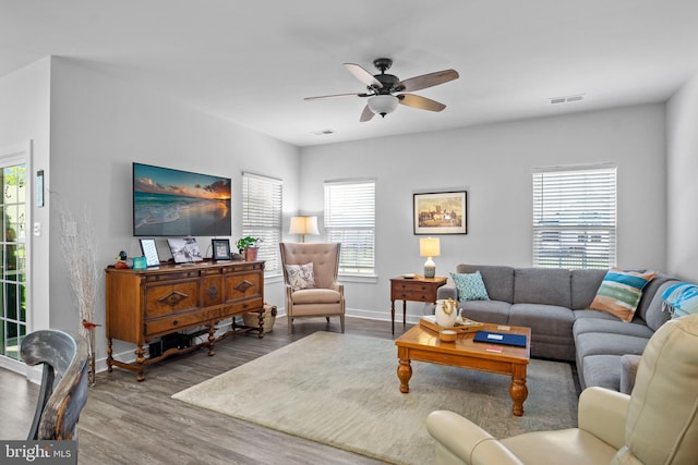 living room featuring ceiling fan and hardwood / wood-style flooring