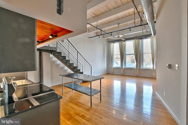 living room with wooden ceiling, hardwood / wood-style floors, and beam ceiling