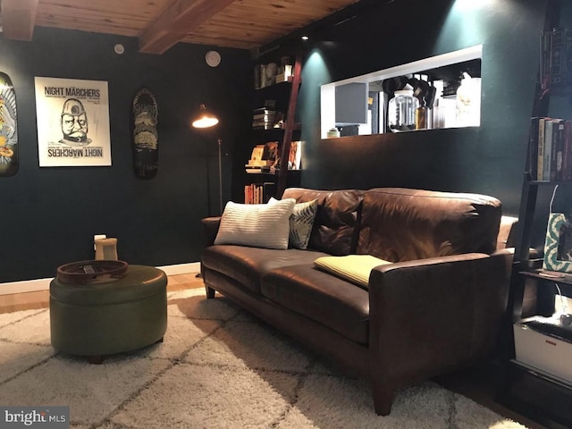 home theater featuring beam ceiling and wooden ceiling