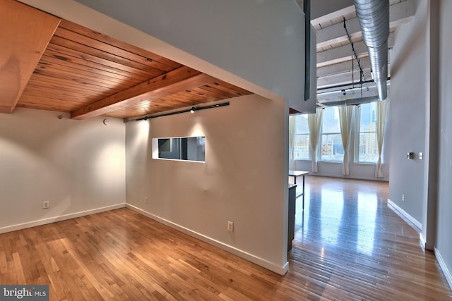 interior space featuring wooden ceiling, beam ceiling, and hardwood / wood-style flooring