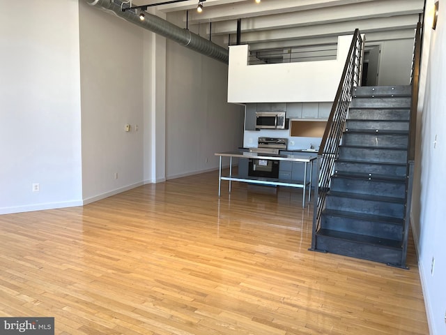 basement featuring light wood-type flooring and sink