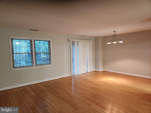 spare room with hardwood / wood-style flooring