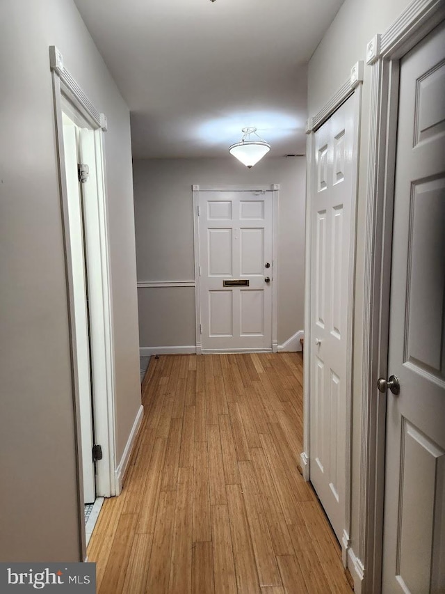 hall with light hardwood / wood-style flooring