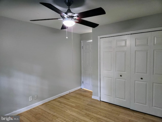 unfurnished bedroom featuring ceiling fan, a closet, and light hardwood / wood-style floors