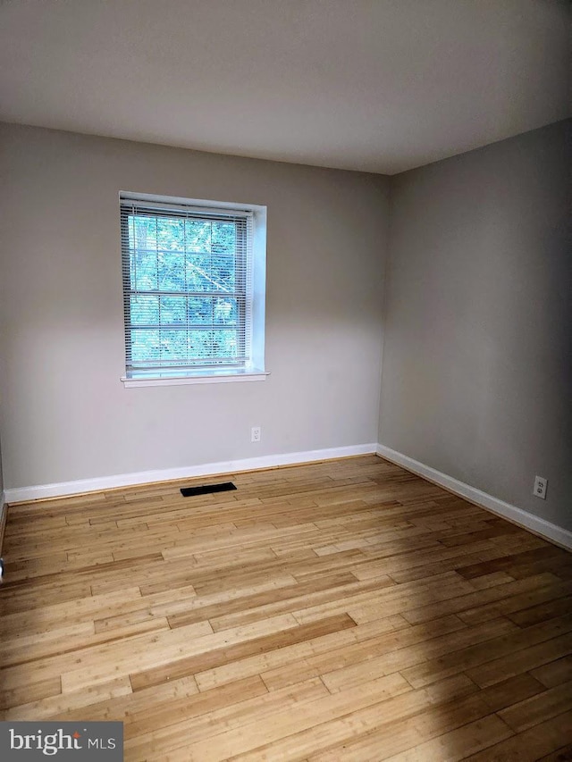 spare room featuring light hardwood / wood-style flooring