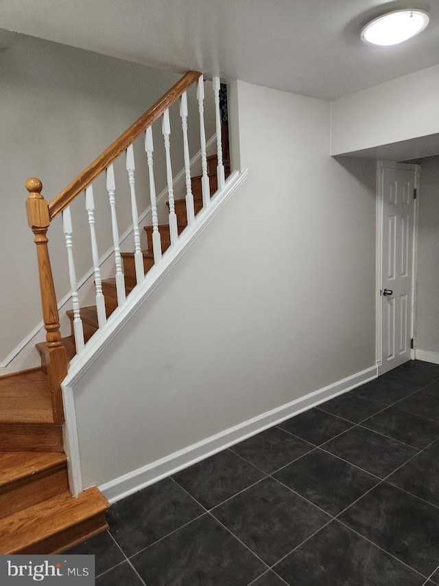 stairs with tile patterned floors