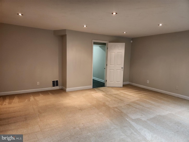 unfurnished room featuring light carpet