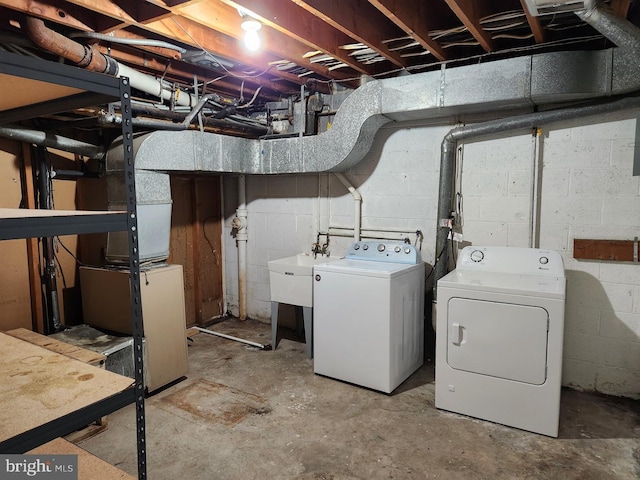 basement featuring sink and separate washer and dryer