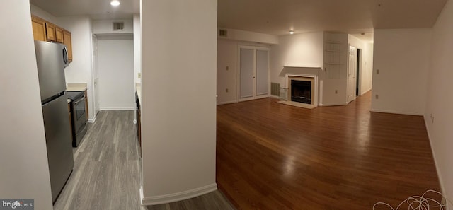 unfurnished living room with dark hardwood / wood-style flooring and a fireplace