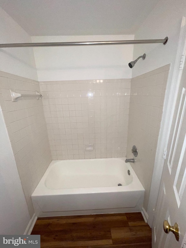 bathroom featuring tiled shower / bath combo and wood-type flooring