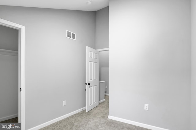 unfurnished bedroom with light colored carpet