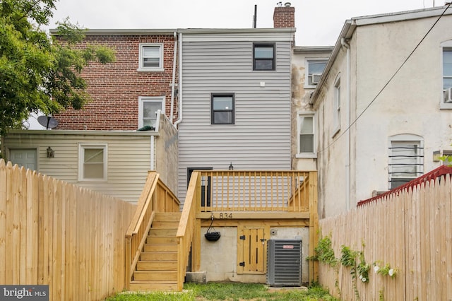 back of property featuring central AC unit