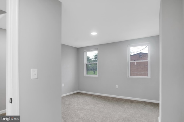 empty room with carpet floors and a healthy amount of sunlight