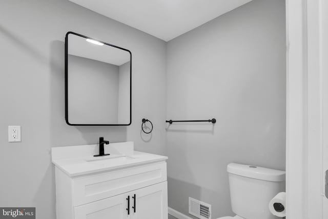 bathroom with toilet and vanity