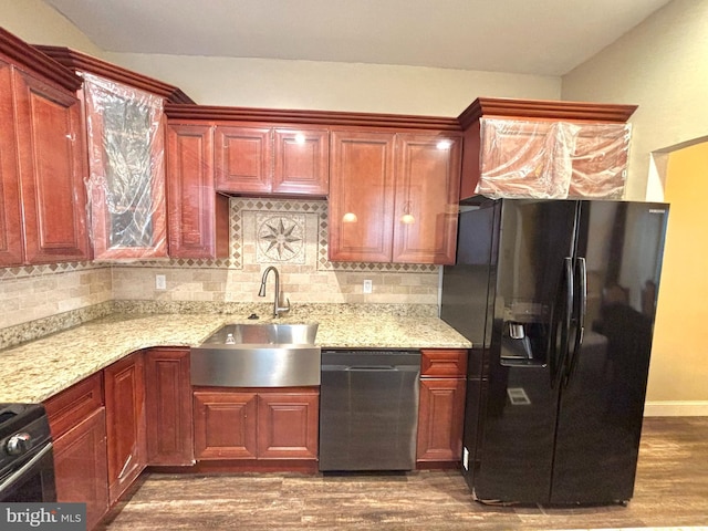 kitchen with wood-type flooring, black fridge with ice dispenser, sink, dishwasher, and backsplash