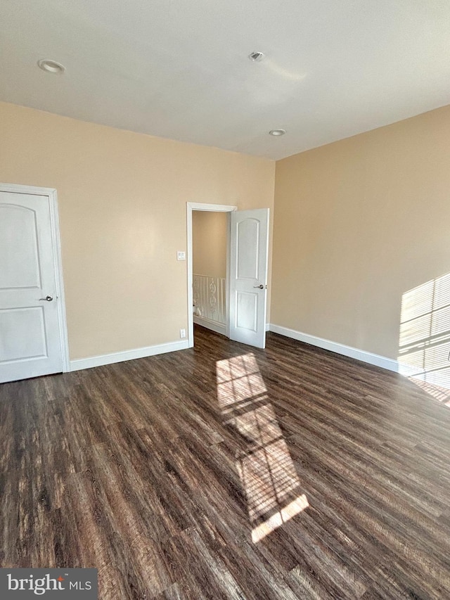 empty room with dark hardwood / wood-style floors