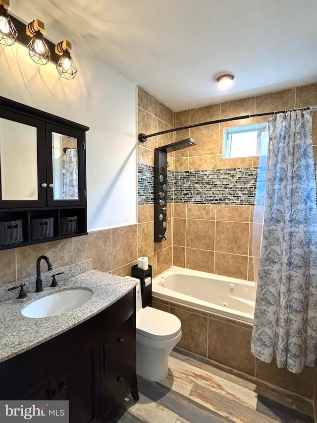 full bathroom featuring tile walls, shower / bathtub combination with curtain, toilet, vanity, and hardwood / wood-style flooring