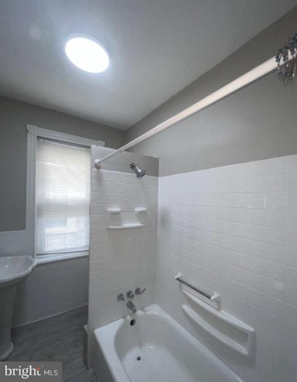 bathroom with tile patterned floors and tiled shower / bath