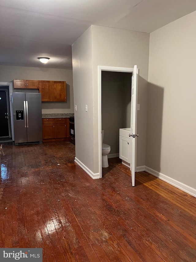 kitchen with stainless steel fridge with ice dispenser and dark hardwood / wood-style floors