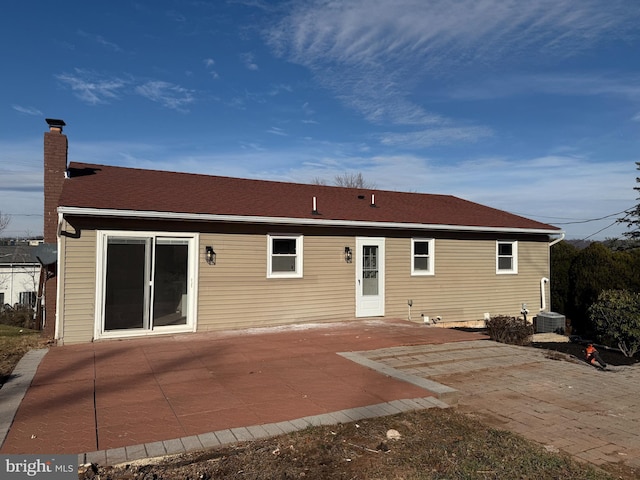 rear view of house featuring a patio and central air condition unit