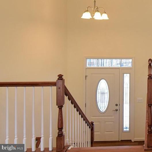 foyer entrance with a notable chandelier