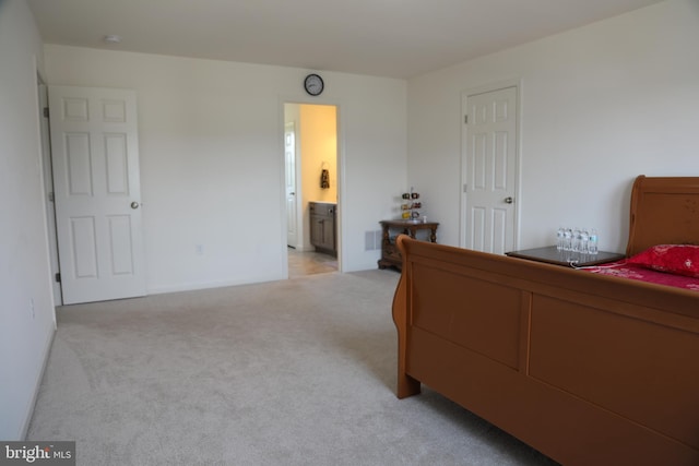 carpeted bedroom featuring connected bathroom