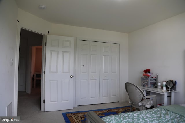 bedroom with carpet floors and a closet