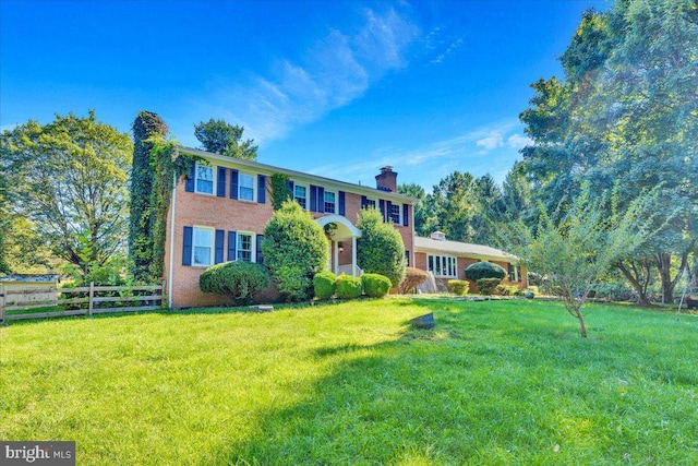 colonial-style house with a front yard