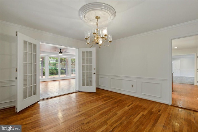 unfurnished dining area featuring hardwood / wood-style floors, french doors, and ornamental molding