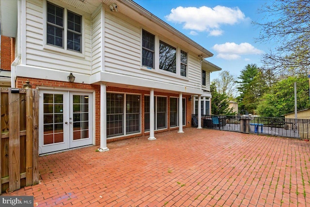 exterior space featuring fence and french doors