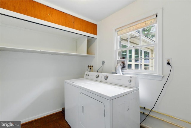 laundry room featuring baseboards, laundry area, and washer / clothes dryer