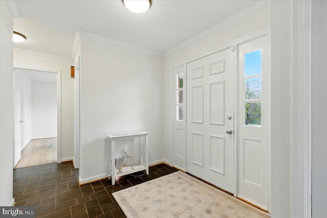 foyer entrance with baseboards and crown molding