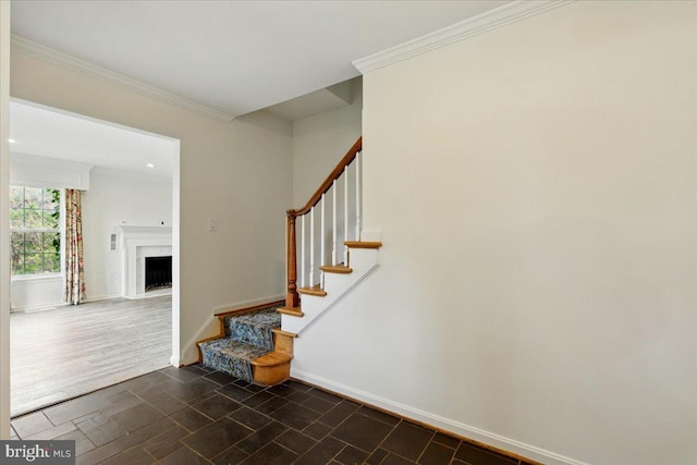 stairway with a fireplace with flush hearth, baseboards, recessed lighting, and ornamental molding