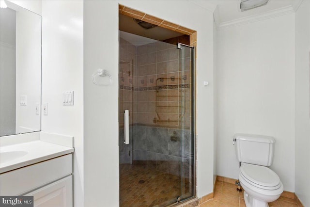 bathroom featuring tile patterned floors, toilet, vanity, ornamental molding, and a stall shower