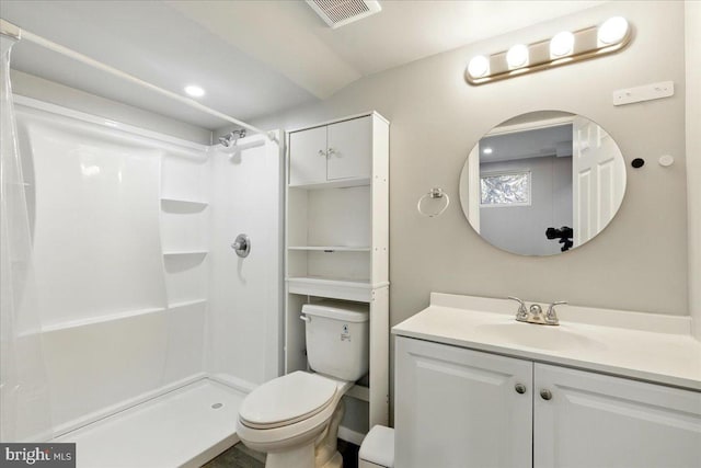 bathroom with vanity, visible vents, a shower, and toilet