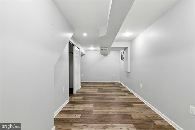 finished below grade area featuring recessed lighting, wood finished floors, and baseboards