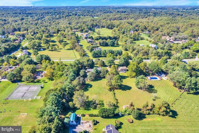birds eye view of property with a view of trees and a rural view