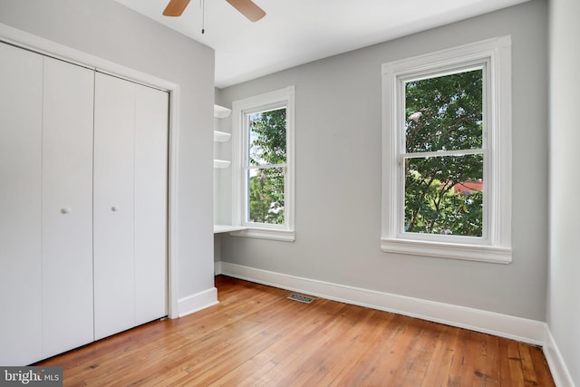 unfurnished bedroom featuring ceiling fan, a closet, and light hardwood / wood-style floors