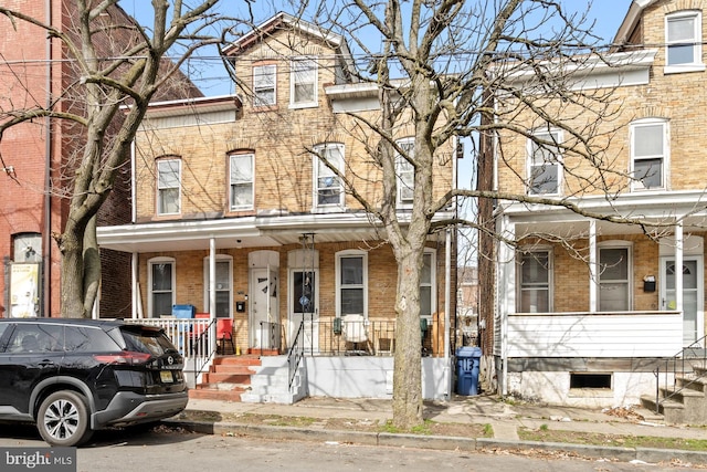 townhome / multi-family property with covered porch