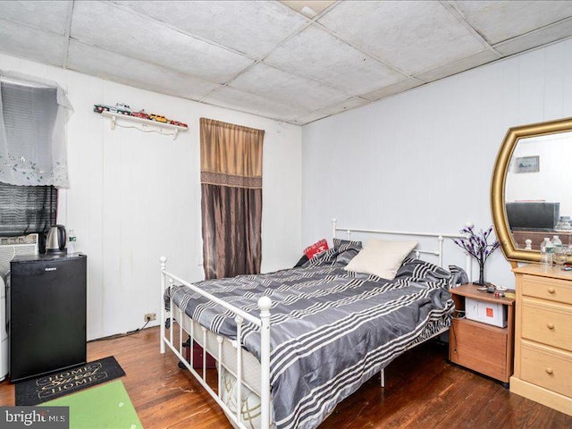 bedroom with dark wood-type flooring