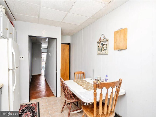 dining space with a paneled ceiling