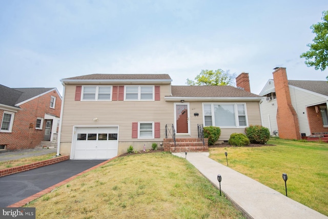 tri-level home with a front lawn and a garage